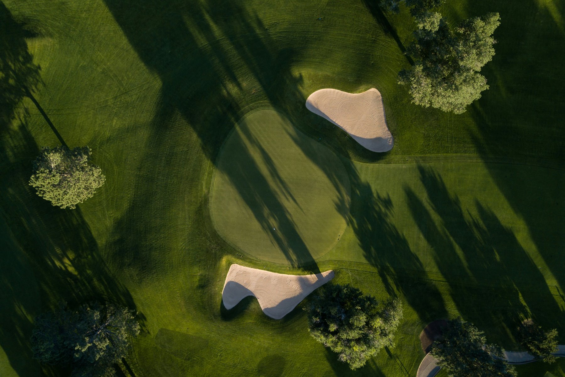 Aerial view of a golf green and sand traps